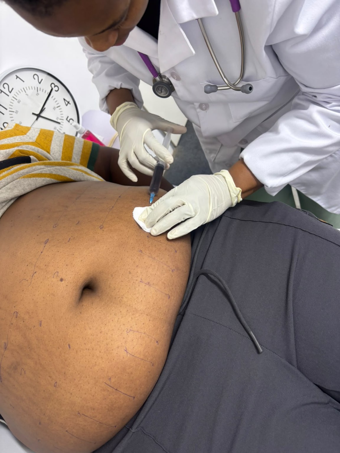 Doctor in uniform providing a body treatment