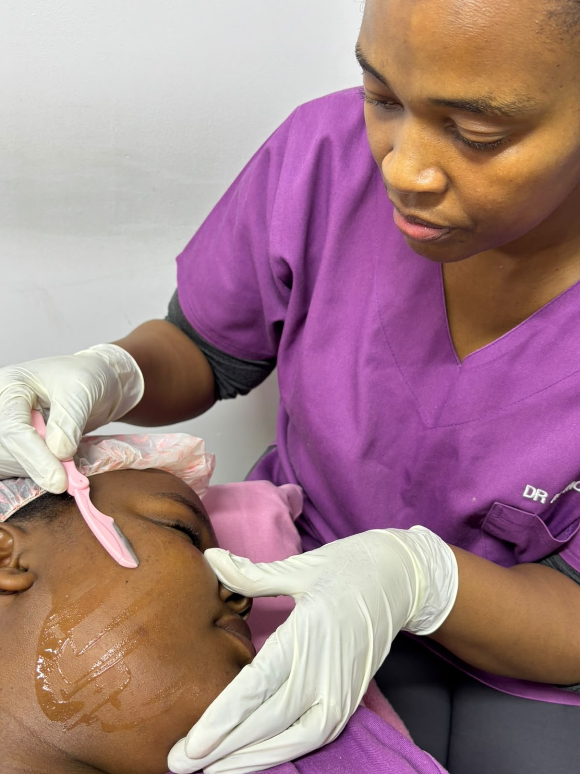 Dr Mahanke providing dermaplaning treatment