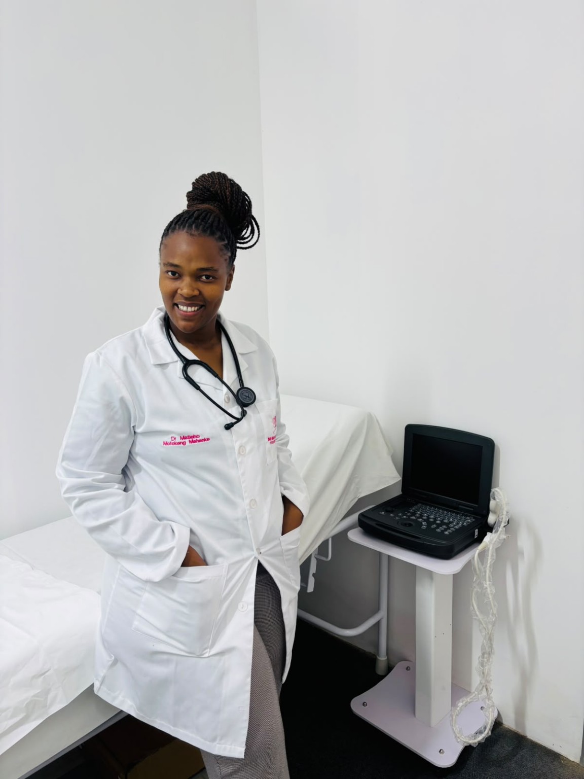 Dr Matieho Mofokeng Mahanke wearing her white coat with her embroidered name and practice logo